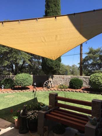another reviewer's backyard with the sail shade over a bench