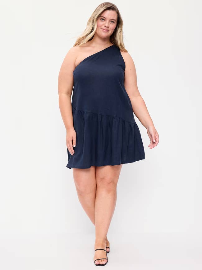 Person wearing a stylish one-shoulder formal  and sandals, posing confidently, suitable for societal  oregon  casual outings