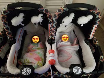 Reviewer's twins sleeping with the white noise machine in their bassinets