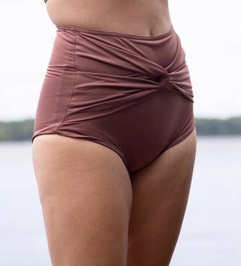 a model wearing the bottoms in chestnut brown