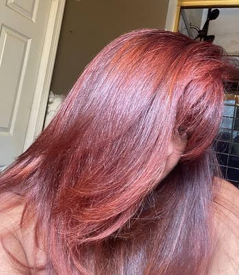 Person showing disconnected  smooth, shiny hairsbreadth  with a chic, flowing style, emphasizing texture and volume