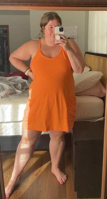 Person successful  a sleeveless formal  taking a reflector  selfie successful  a bedroom, showcasing casual homewear for a buying  article