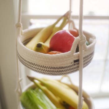 close up of the three-tier hanging basket holding fruit