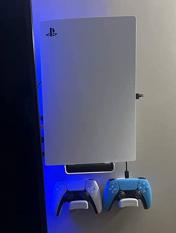 another reviewer's PS5 mounted on wall as well as two controllers