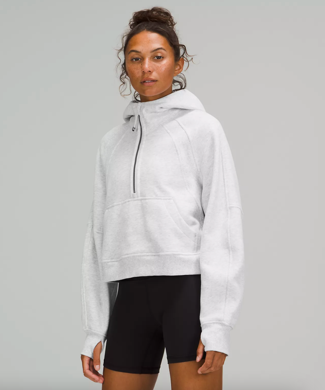 model wearing the hoodie in light grey