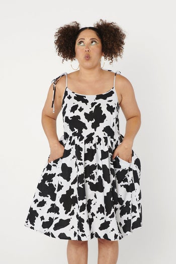 Model wearing the cow print slip dress, front view