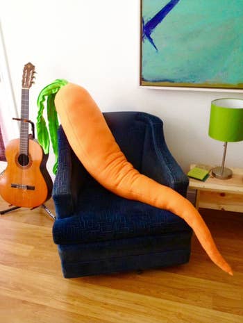 Image of the carrot pillow on a blue chair