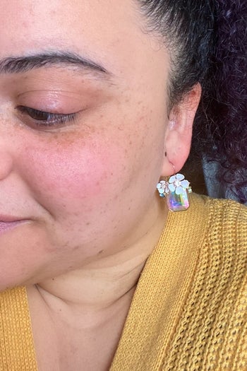 BuzzFeed editor Kayla wearing the earrings