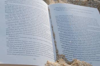 open page to a book in the sand
