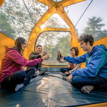 four people inside the tent 