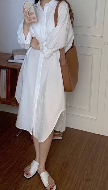 model wearing the oversized shirt dress in white