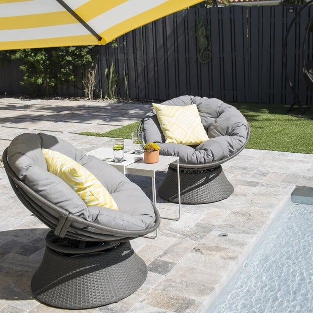 Image of two gray outdoor Papasan chairs next to a pool