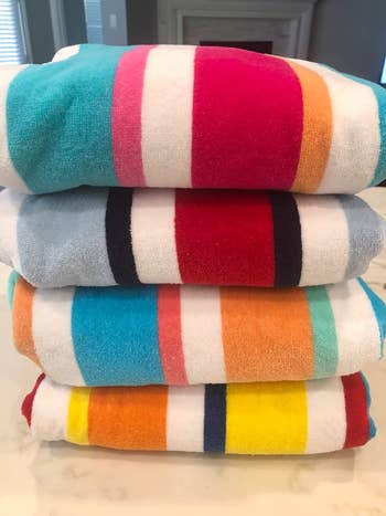 reviewer photo of a stack of four multicolored striped towels