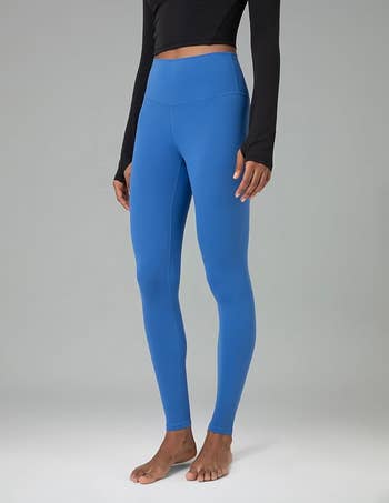 model in the blue high-waisted leggings