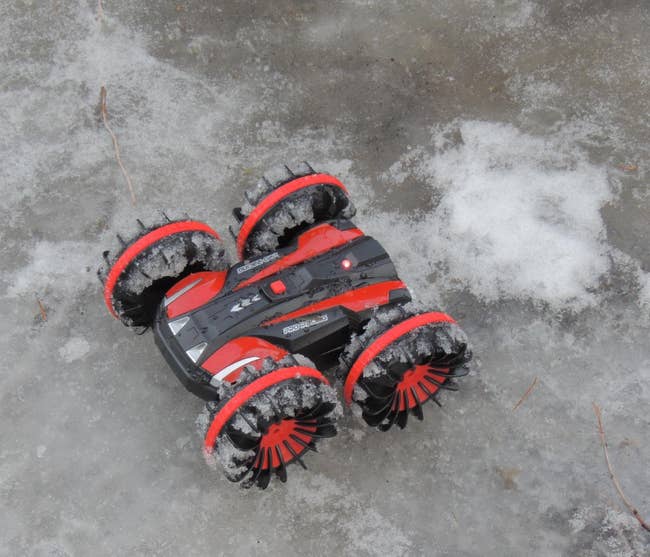 Reviewer's photo showing the red remote control car on the icy ground