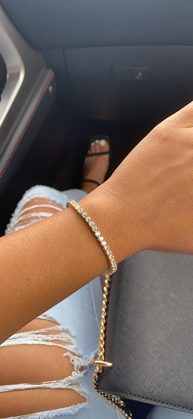 reviewer wearing the golden  bracelet connected  their wrist