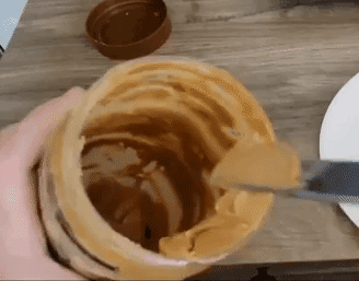 gif of reviewer using it to scrape last bit of PB from a nearly empty jar