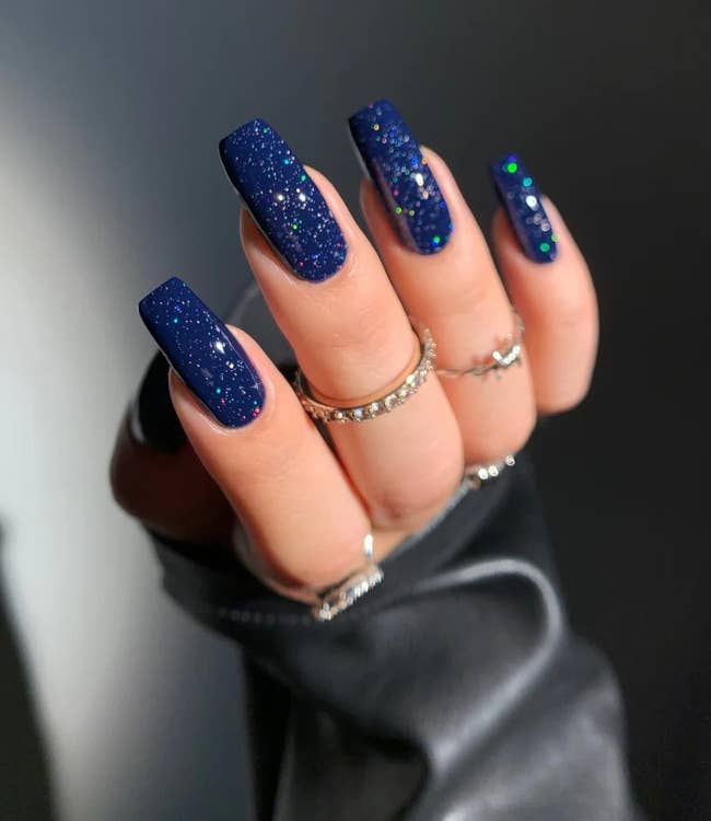 dark blue nails with the clear glitter top coat on top