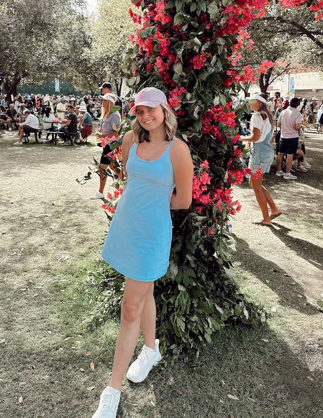reviewer posing in light blue tennis dress