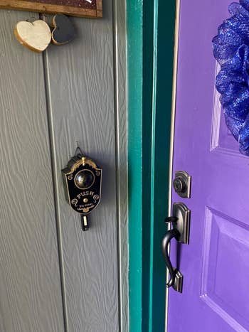 the doorbell with the eye closed hanging by a reviewer's purple door