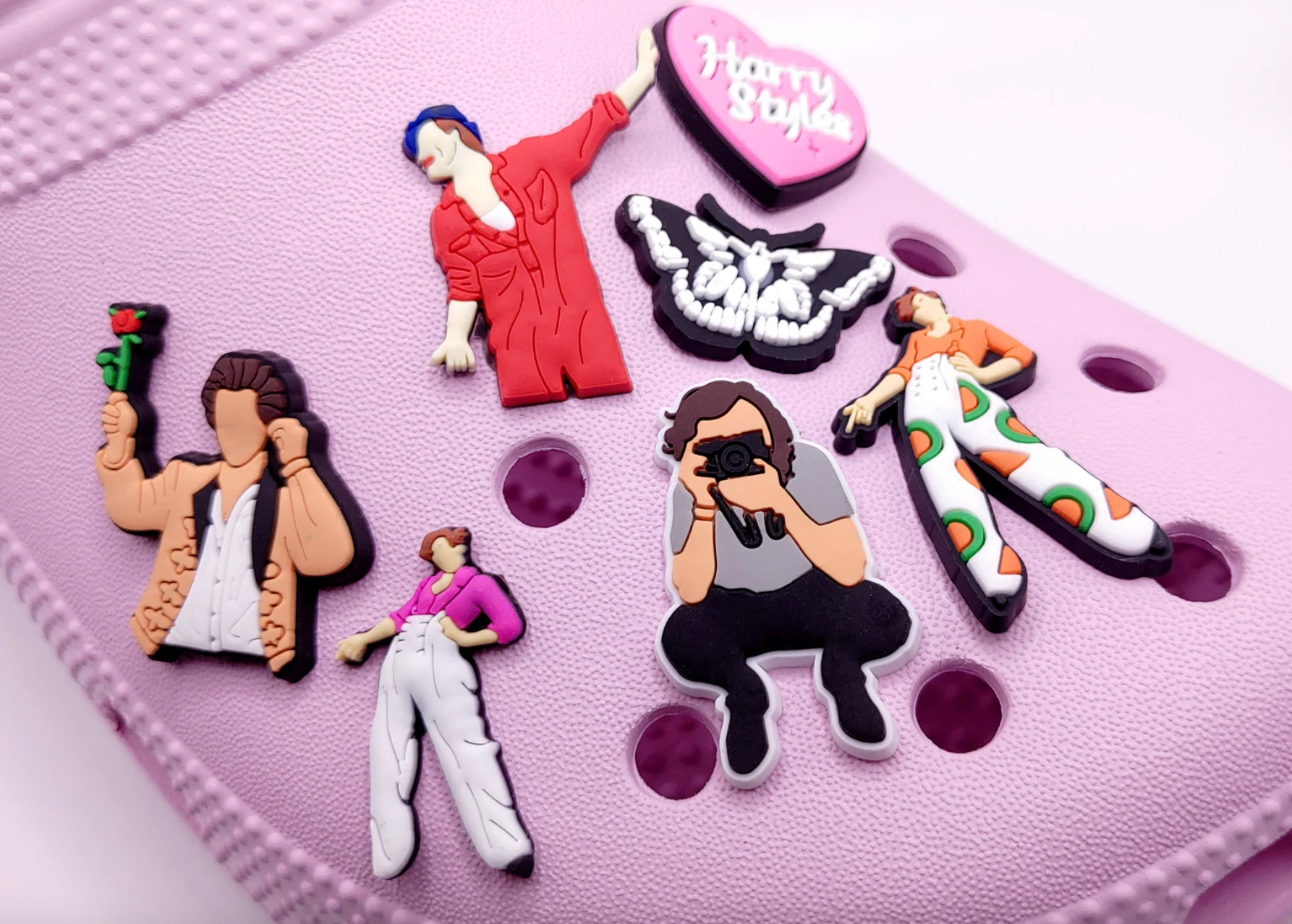 various harry charms on a pink croc shoe