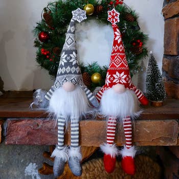 a pair of decorative gnomes wearing holiday outfits 