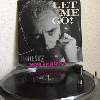 A record leans on the NOW SPINNING ledge