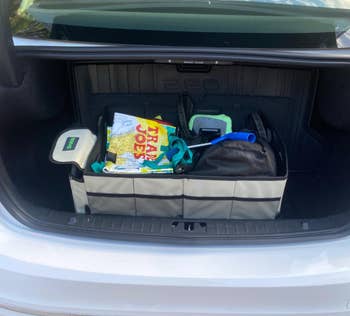 Collapsible organizer in the back of reviewer's sedan filled with objects