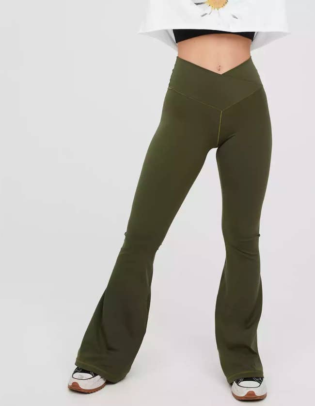 model wearing the cross-waist flare leggings in olive green