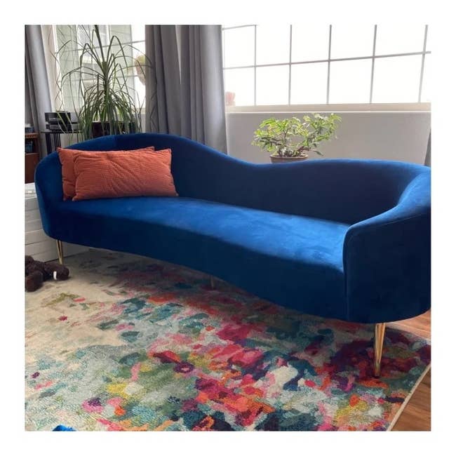 reviewer photo of the blue sofa in a living room