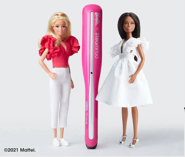 Pink and silver straightener in the middle of two Barbie dolls