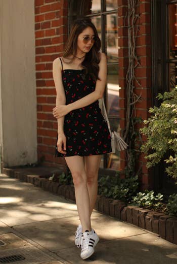 reviewer wearing dress with sneakers