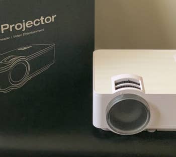 a reviewer photo of the small white projector 