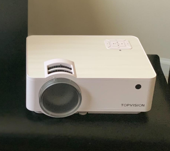 a reviewer photo of the small white projector 