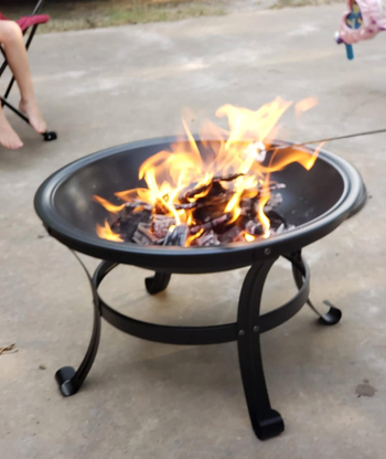 reviewer using fire pit
