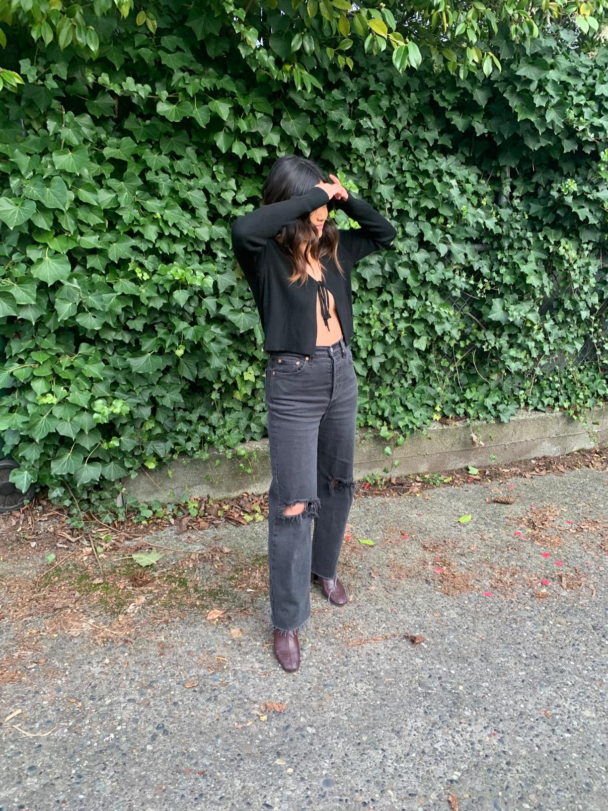 reviewer wearing the jeans in distressed black