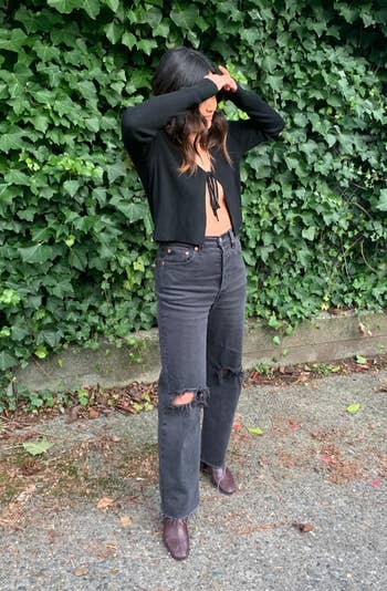 reviewer wearing the jeans in distressed black