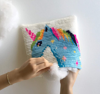 closeup of hands making unicorn pillow