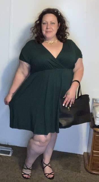 reviewer wearing the dress in jade green