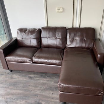 reviewer photo of brown faux leather sectional