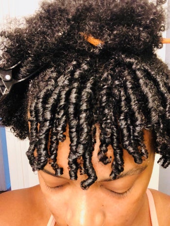 reviewer with natural hair showing off their defined curls