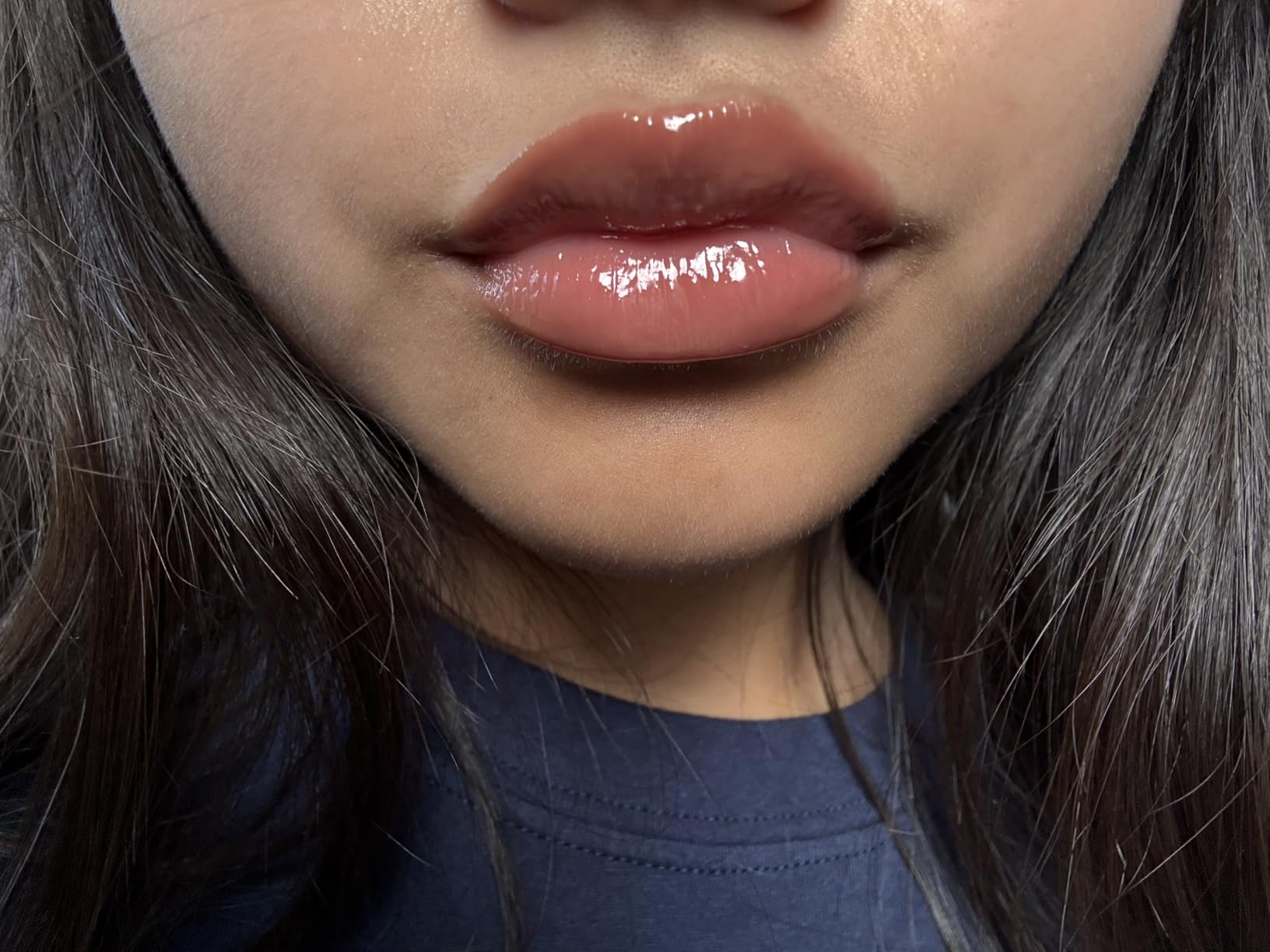 Close-up of a person's lips with glossy lipstick, showcasing a quality   product