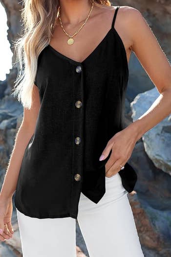 a black button down shirt with a v-neckline and straps on a model