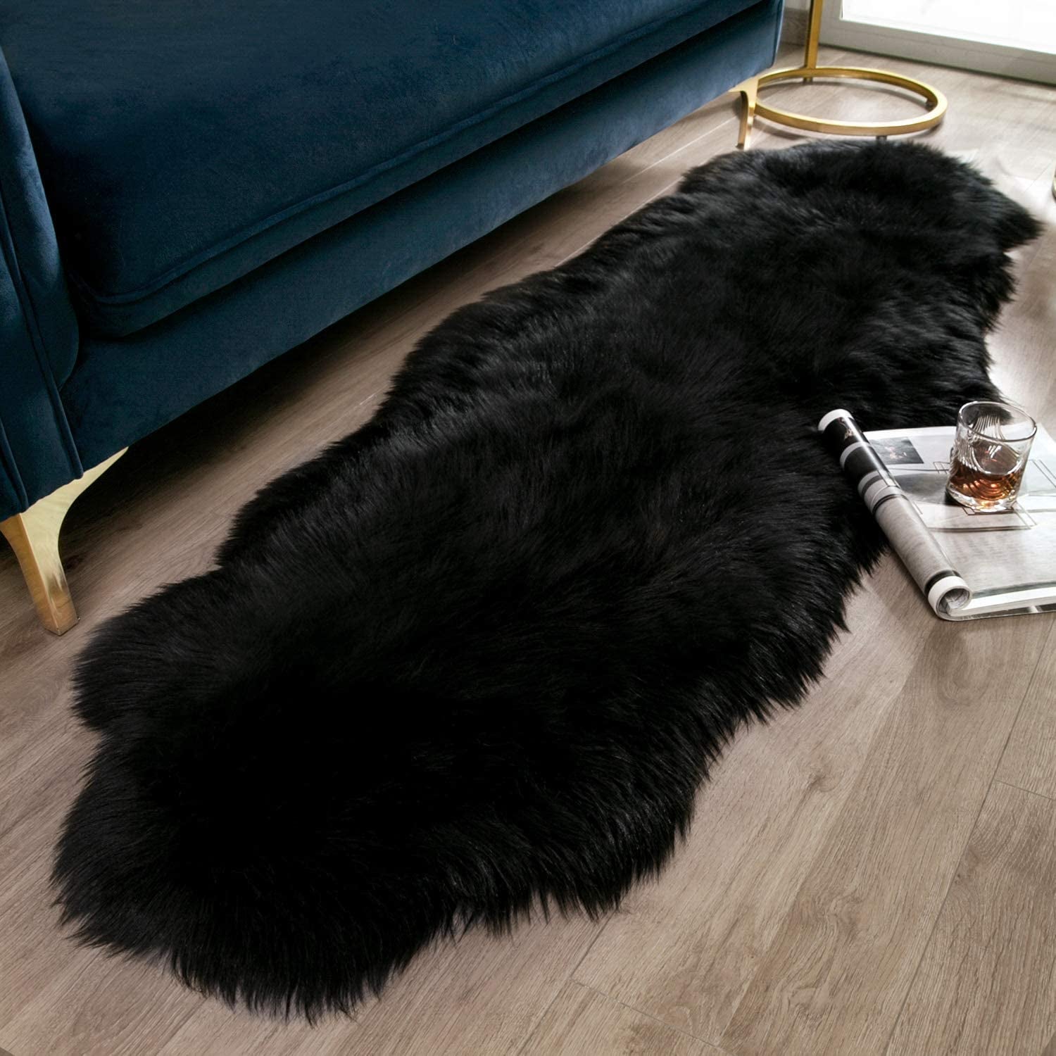 black shaggy faux rug in front of a couch