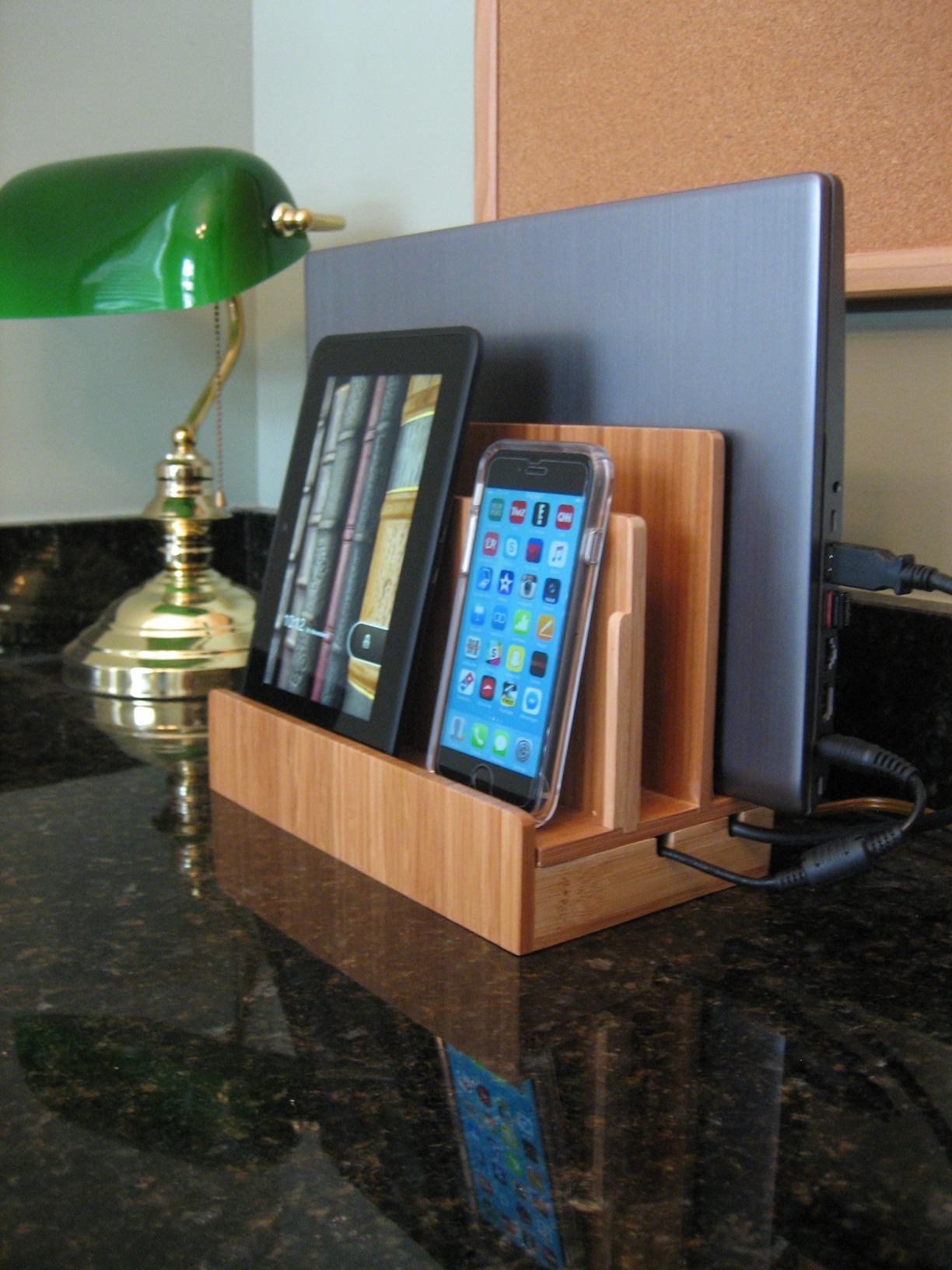 A multi-device charging station with a tablet and a smartphone docked on a counter