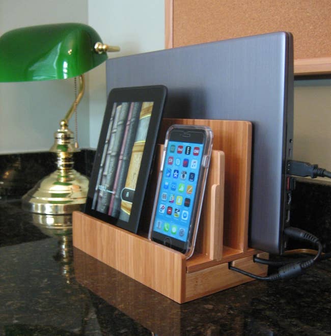 A multi-device charging station with a tablet and a smartphone docked on a counter
