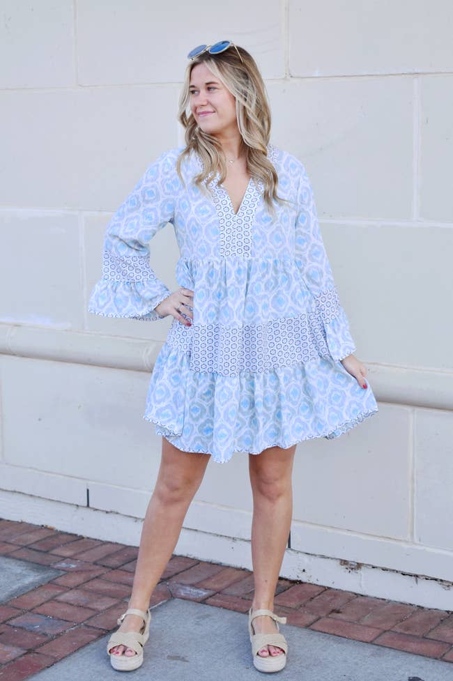 model in the long sleeve mini dress with mixed blue and white prints