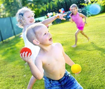 Children running around throwing the balls 