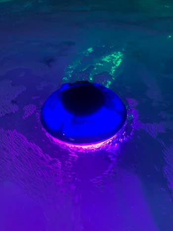 Glowing floating talker  successful  h2o  emits purple light, showcasing its waterproof design