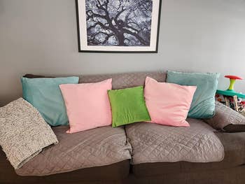 pink blue and green pillows on couch